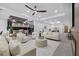 Bright, open living room featuring modern furniture, a ceiling fan, and views into the kitchen at 1905 W Erna Dr, Tampa, FL 33603