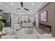 Spacious living room with a modern fireplace, ceiling fan, and view of the open floor plan at 1905 W Erna Dr, Tampa, FL 33603