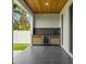 Covered outdoor kitchen boasts a wood plank ceiling and a wine refrigerator at 1905 W Erna Dr, Tampa, FL 33603