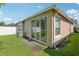 View of the back of the house, showing the patio and well-maintained lawn at 31447 Shaker Cir, Wesley Chapel, FL 33543