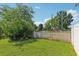 Backyard featuring a grassy area and a tall privacy fence at 31447 Shaker Cir, Wesley Chapel, FL 33543