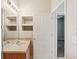 Bathroom sink with storage and a doorway to another room at 31447 Shaker Cir, Wesley Chapel, FL 33543