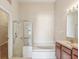Bright bathroom showcases both a glass door shower and a tub with neutral walls at 31447 Shaker Cir, Wesley Chapel, FL 33543