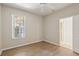 Cozy bedroom featuring new floors, neutral walls and window to the outside at 31447 Shaker Cir, Wesley Chapel, FL 33543