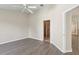 Bedroom with wood floors, ceiling fan, and a doorway to the bathroom at 31447 Shaker Cir, Wesley Chapel, FL 33543