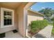 Covered front porch with a view of the entrance door and a large window at 31447 Shaker Cir, Wesley Chapel, FL 33543