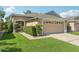 Charming single-story home featuring a well-manicured lawn and a two-car garage at 31447 Shaker Cir, Wesley Chapel, FL 33543
