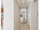 Hallway leading to kitchen and open floor plan with tile floors at 31447 Shaker Cir, Wesley Chapel, FL 33543