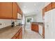 Spacious kitchen with wood cabinetry, white appliances and tile flooring at 31447 Shaker Cir, Wesley Chapel, FL 33543