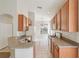 Open kitchen with wood cabinets, tile backsplash, double sink, and gas range at 31447 Shaker Cir, Wesley Chapel, FL 33543