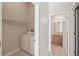 Laundry room with washer and dryer including a view to the bathroom at 31447 Shaker Cir, Wesley Chapel, FL 33543