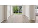 Light-filled living area with sliding glass doors leading to a well-maintained backyard at 31447 Shaker Cir, Wesley Chapel, FL 33543