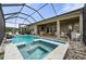 View of the screened in pool and hot tub area with outdoor furniture and patio at 3221 Acacia Bay Dr, Wesley Chapel, FL 33543