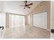Bright bedroom featuring vaulted ceilings, ceiling fan, and tile floors at 9406 Citrus Glen Pl, Tampa, FL 33618