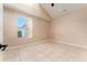Bright bedroom featuring a window and tile floors at 9406 Citrus Glen Pl, Tampa, FL 33618
