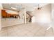 Open-concept living room with tile floors, staircase, and natural light at 9406 Citrus Glen Pl, Tampa, FL 33618