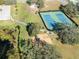 Aerial view of the recreational area featuring tennis courts and a playground at 9406 Citrus Glen Pl, Tampa, FL 33618