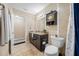 Bright bathroom featuring a toilet, shower and granite countertops with modern fixtures at 11201 Knotty Pine Dr, New Port Richey, FL 34654