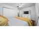 Comfortable bedroom featuring a closet, ceiling fan and a dresser with a television at 11201 Knotty Pine Dr, New Port Richey, FL 34654