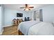 Comfortable bedroom with wood floors, a ceiling fan, television and a large closet at 11201 Knotty Pine Dr, New Port Richey, FL 34654