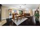 Dining room featuring hardwood floors that flow into a spacious kitchen, creating an inviting atmosphere at 11201 Knotty Pine Dr, New Port Richey, FL 34654