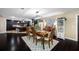 Bright dining room features a large window and is open to the modern kitchen and elegant front entrance at 11201 Knotty Pine Dr, New Port Richey, FL 34654