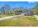 Charming single-story home with a well-manicured lawn and a white picket fence at 11201 Knotty Pine Dr, New Port Richey, FL 34654