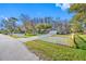 Charming single story home boasts a well-maintained lawn with a white picket fence and a two-car garage at 11201 Knotty Pine Dr, New Port Richey, FL 34654