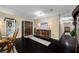 Elegant foyer featuring hardwood floors and a charming display cabinet with sophisticated decor accents at 11201 Knotty Pine Dr, New Port Richey, FL 34654