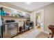 Clean laundry room featuring stainless steel appliances, storage, and a shower stall at 11201 Knotty Pine Dr, New Port Richey, FL 34654