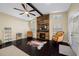 Living room featuring dark wood floors, a stacked wood accent wall, an electric fireplace and neutral furniture at 11201 Knotty Pine Dr, New Port Richey, FL 34654
