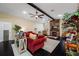 Spacious living room featuring dark wood floors, a stacked wood accent wall with a fireplace, and comfortable seating at 11201 Knotty Pine Dr, New Port Richey, FL 34654