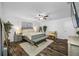 Bright main bedroom with a ceiling fan, accent rug, and ample natural light from the window at 11201 Knotty Pine Dr, New Port Richey, FL 34654