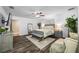 Bright main bedroom boasts a ceiling fan, accent rug, hardwood floors, and plenty of natural light at 11201 Knotty Pine Dr, New Port Richey, FL 34654