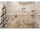 Walk-in shower with dual shower heads and neutral stone-look tile at 11201 Knotty Pine Dr, New Port Richey, FL 34654
