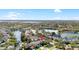 This aerial view shows a lake community, highlighting the home's location near the water at 1600 Gray Bark Dr, Oldsmar, FL 34677