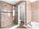 Bathroom showcasing a tiled shower with glass door, and bathtub with matching tile throughout at 1600 Gray Bark Dr, Oldsmar, FL 34677