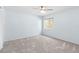 Bright bedroom features neutral carpeting, a ceiling fan, and a sunny window at 1600 Gray Bark Dr, Oldsmar, FL 34677