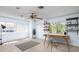 Bright bedroom features a modern desk, shelves, lots of windows, and light wood floors at 1600 Gray Bark Dr, Oldsmar, FL 34677