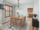 Well-lit dining room with light wood furniture, modern light fixture, and a view of the kitchen at 1600 Gray Bark Dr, Oldsmar, FL 34677