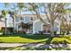 Charming two-story home features a well-manicured lawn, mature trees and tasteful landscaping at 1600 Gray Bark Dr, Oldsmar, FL 34677