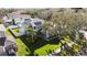 Charming home featuring solar panels, a lush lawn, and mature trees at 1600 Gray Bark Dr, Oldsmar, FL 34677