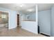 Hallway with blue walls and wood floors, has access to bathroom, closet, and bedroom at 1600 Gray Bark Dr, Oldsmar, FL 34677