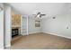 Spacious living room featuring a fireplace with stone accents, built-in shelving, and wood laminate flooring at 1600 Gray Bark Dr, Oldsmar, FL 34677