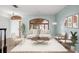 Bright living room with an arched window, modern furniture, light wood floors, and stylish decor at 1600 Gray Bark Dr, Oldsmar, FL 34677