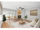 Cozy living room featuring a brick fireplace, built-in shelving, and access to the backyard at 1600 Gray Bark Dr, Oldsmar, FL 34677