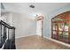 Bright living room with wood-look floors, custom window shutters, and elegant light fixture at 1600 Gray Bark Dr, Oldsmar, FL 34677