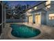Screened in kidney-shaped pool surrounded by brick pavers offers a private outdoor space at 1600 Gray Bark Dr, Oldsmar, FL 34677