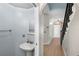 Hallway view to Powder Room with pedestal sink and hardwood floors at 1600 Gray Bark Dr, Oldsmar, FL 34677