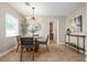 Elegant dining room with modern lighting, stylish decor, and a view into the kitchen at 3616 W Morrison Ave, Tampa, FL 33629